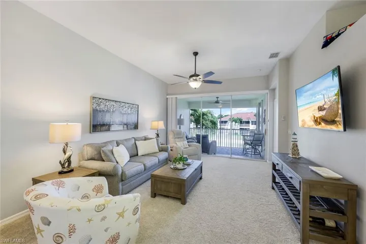 Neutral color palette, open floor plan, spacious design with tall ceilings and sliding glass doors that open out to your lanai with water and fountain views.