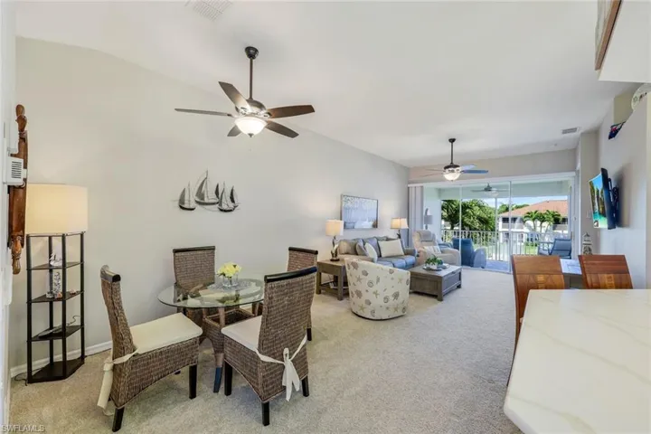 Open floor plan with dining area, living room, kitchen, and lanai with water and fountain views.