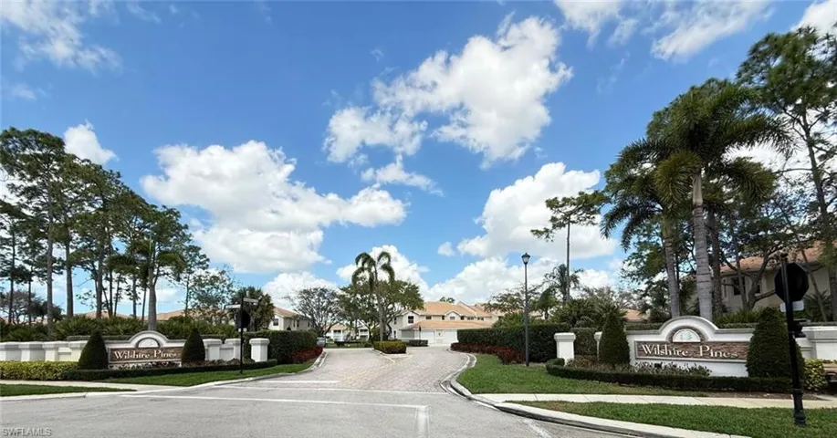 View of asphalt street featuring sidewalks, street lighting, curbs, and a residential view