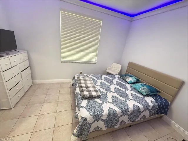 Bedroom featuring baseboards and light tile patterned floors