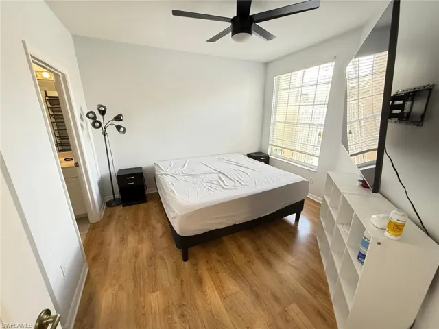 Bedroom with wood finished floors and a ceiling fan