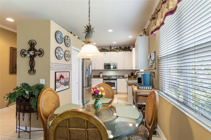 Tiled dining space with sink and ornamental molding