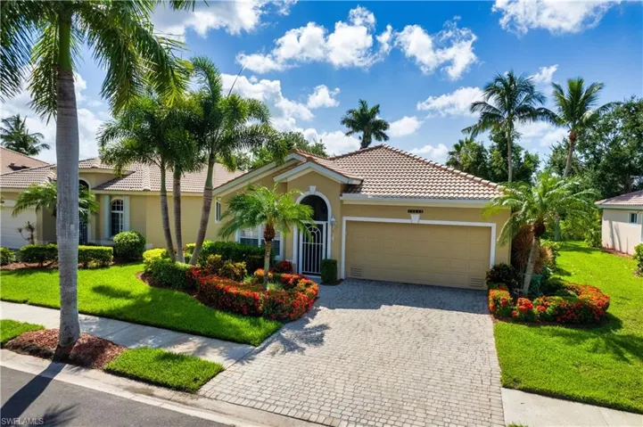 Mediterranean / spanish home with a garage and a front lawn