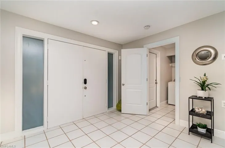 Tiled foyer  with garage and laundry to the left