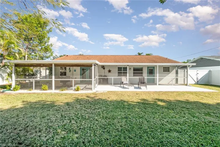 Back of property with a yard, a patio area