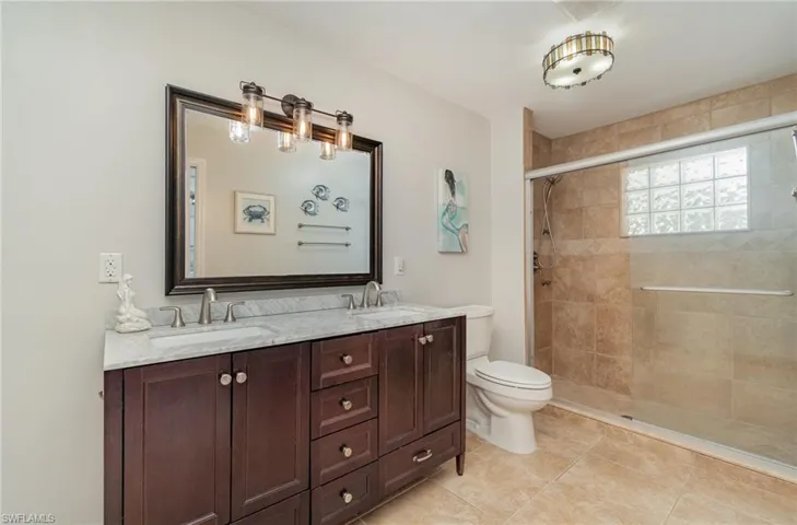 Renovated owners suite  with double sinks and multi shower sprays