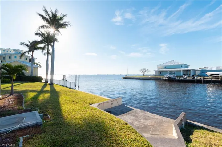 View of dock with a water view and a yard