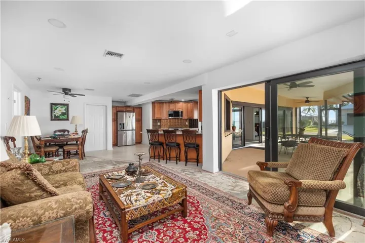 Living room featuring visible vents and ceiling fan
