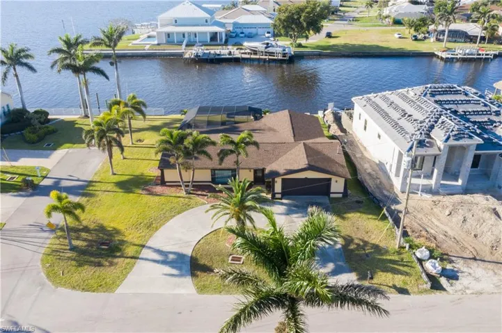 Birds eye view of property with a residential view and a water view