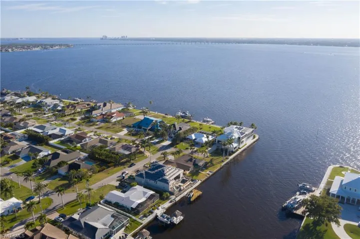 Birds eye view of property featuring a water view and a residential view