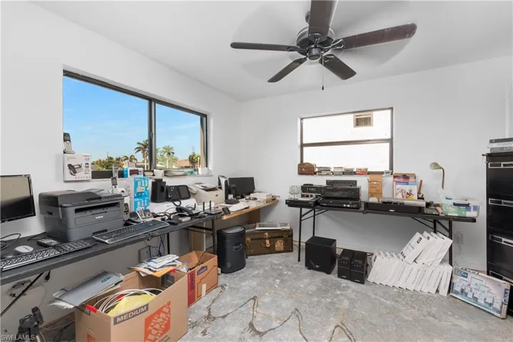 Home office featuring a ceiling fan and plenty of natural light