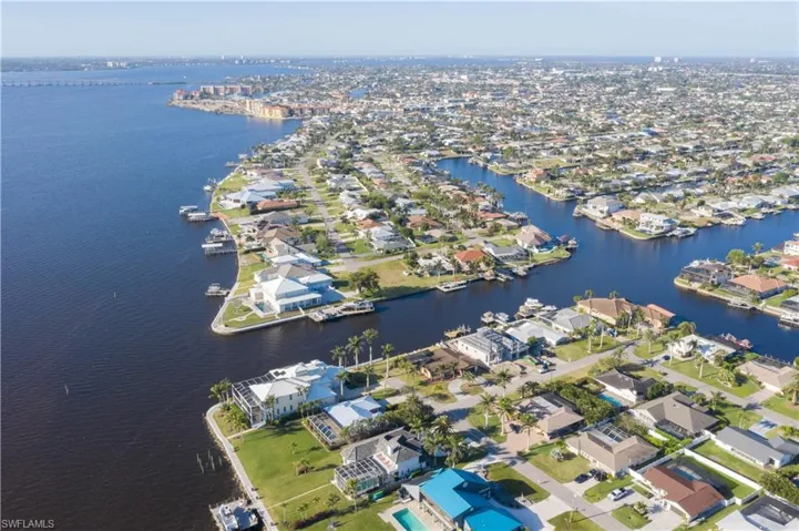 Birds eye view of property featuring a water view and a residential view