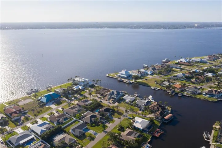 Birds eye view of property featuring a water view and a residential view
