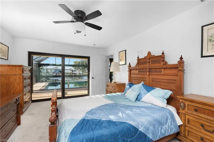 Bedroom featuring access to exterior, a ceiling fan, and light carpet