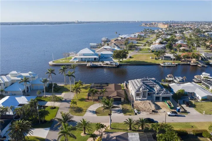 Birds eye view of property featuring a water view and a residential view
