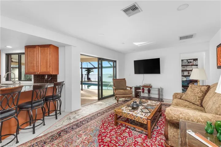 Living room featuring visible vents and recessed lighting