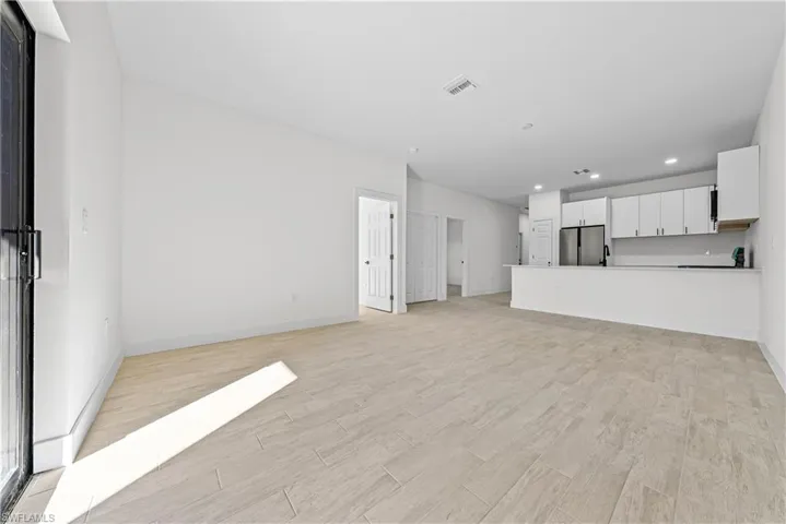 Unfurnished living room featuring light wood-style flooring and recessed lighting