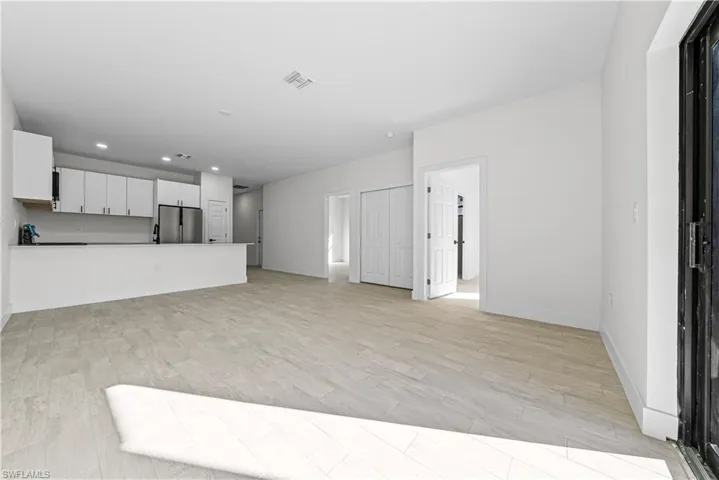 Unfurnished living room featuring light wood finished floors and recessed lighting