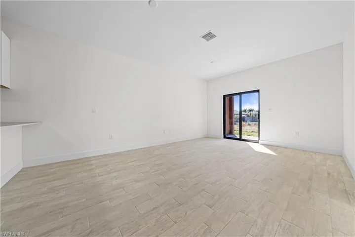 Spare room featuring wood tiled floors and baseboards