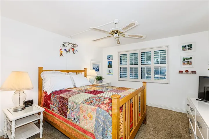 Bedroom featuring carpet, baseboards, and ceiling fan