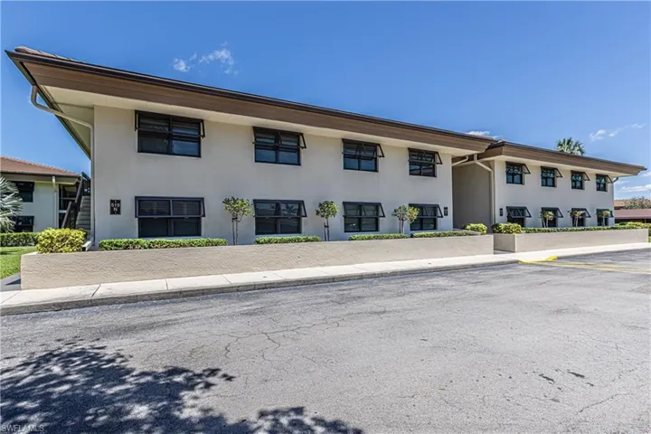 View of property with uncovered parking