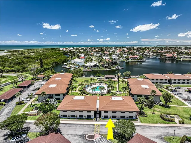 Aerial perspective of suburban area featuring a nearby body of water