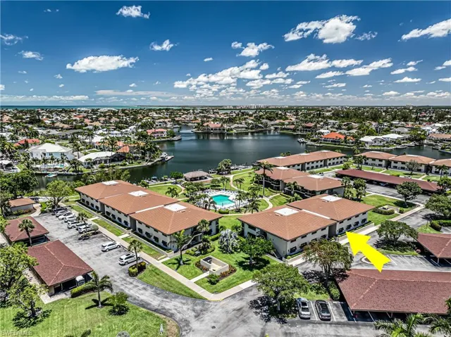 Aerial perspective of suburban area featuring a large body of water