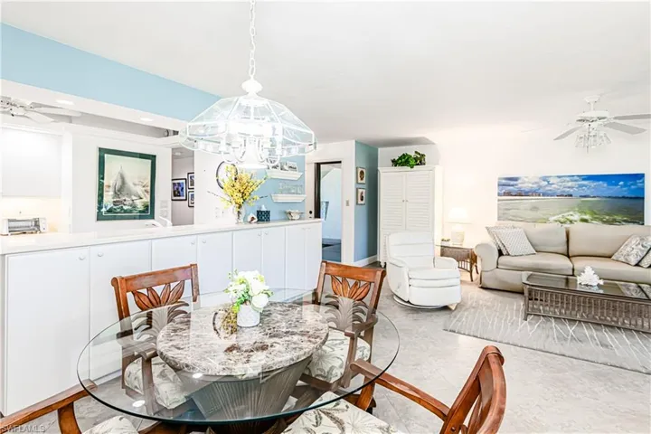 Dining room featuring a ceiling fan, a chandelier, and recessed lighting