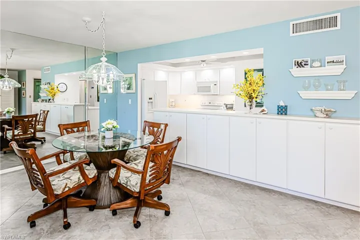 Dining area featuring a chandelier, light tile patterned floors, and ceiling fan