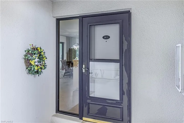 Property entrance with stucco siding