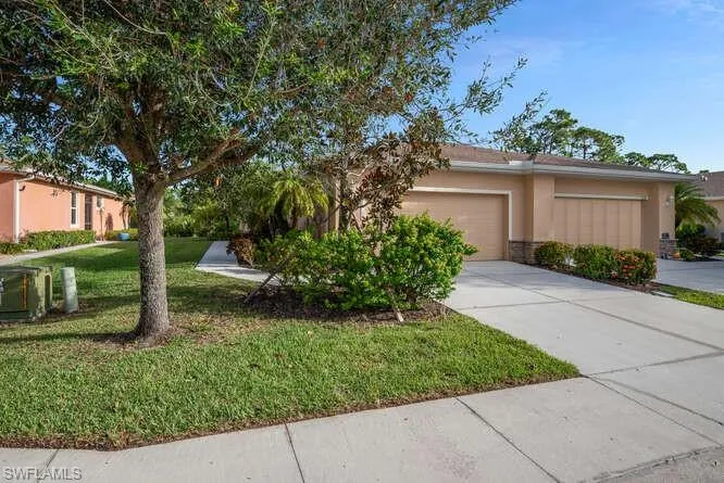 View of front facade with a front yard and a garage