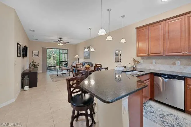 Kitchen with dishwasher, kitchen peninsula, ceiling fan, and sink
