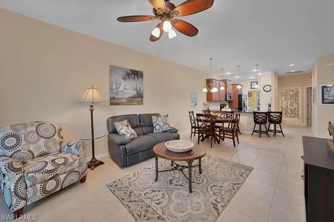 Living room featuring ceiling fan and light tile patterned flooring
