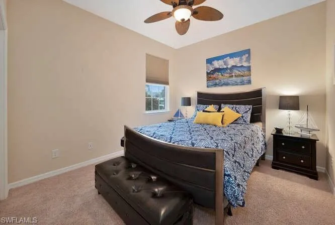 Bedroom with ceiling fan and light carpet