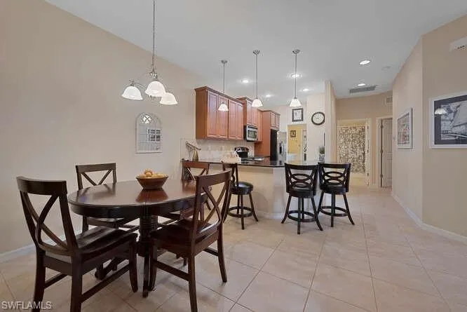 Dining room featuring a notable chandelier and light tile patterned floors
