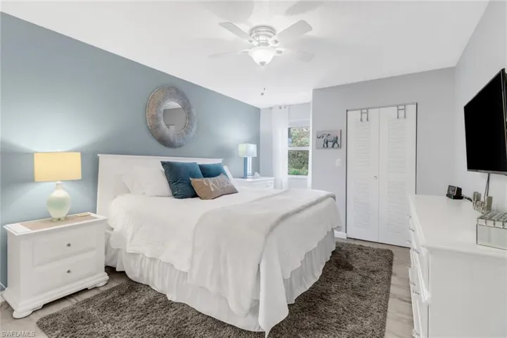 Bedroom with a closet, ceiling fan, and light hardwood / wood-style floors