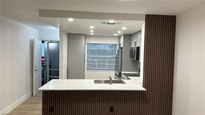 Bathroom with recessed lighting, vanity, and light wood-style flooring