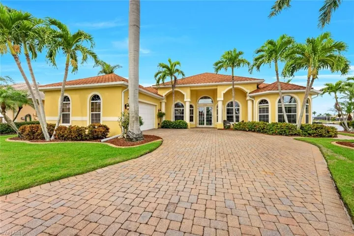 Mediterranean / spanish-style house featuring french doors, a front yard, and a garage