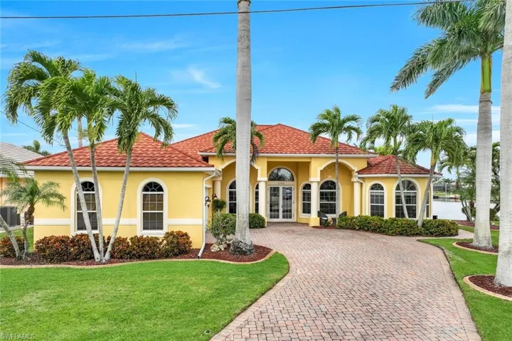Mediterranean / spanish house featuring a front lawn and french doors