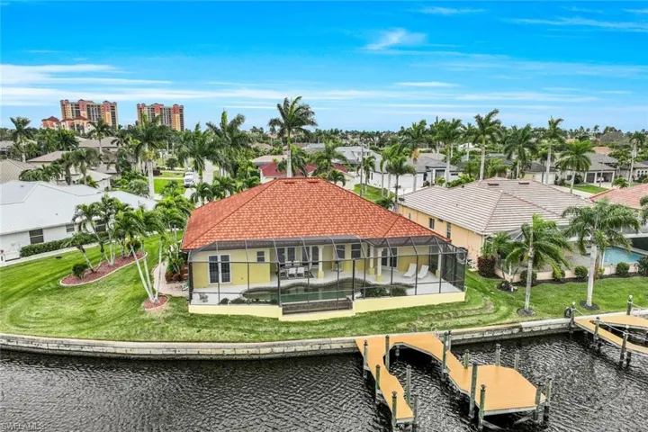 Birds eye view of property with a water view