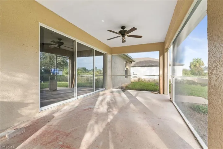 Unfurnished sunroom featuring ceiling fan