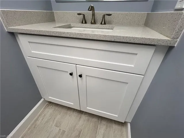 Interior details with hardwood / wood-style floors and vanity