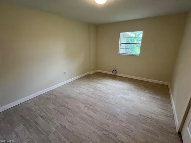 Empty room featuring hardwood / wood-style floors