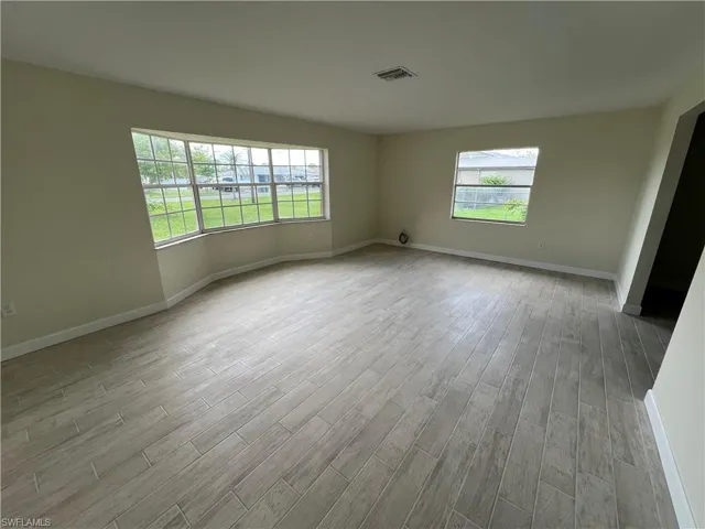 Spare room with light hardwood / wood-style floors and a healthy amount of sunlight