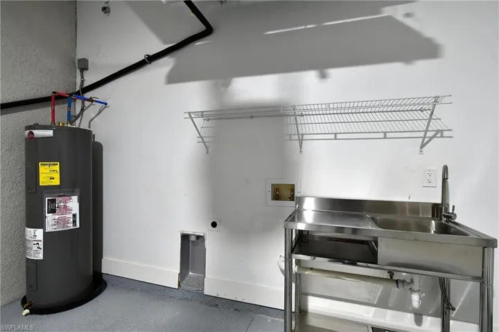 Laundry room featuring hookup for a washing machine, water heater, and electric dryer hookup
