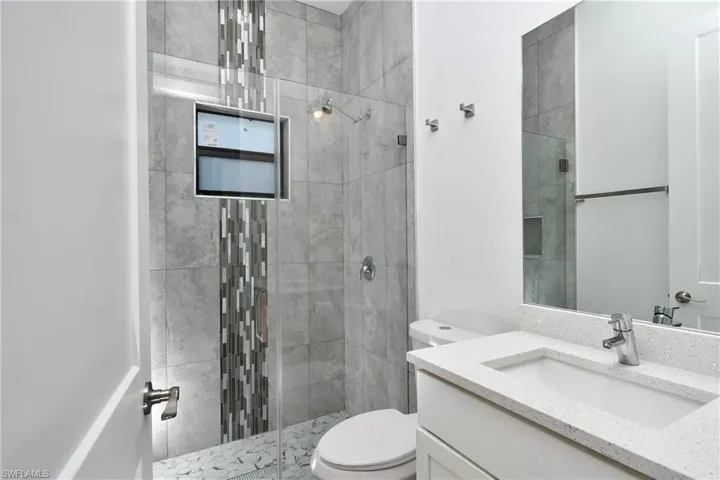 Bathroom featuring vanity and a stall shower
