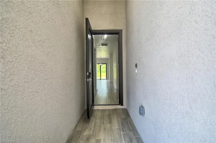 Entrance to property with stucco siding