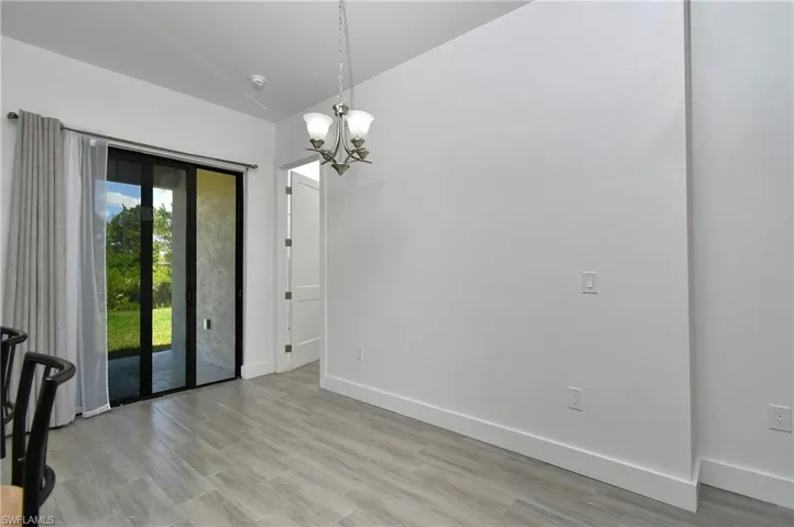 Unfurnished dining area featuring suspended lighting and light wood-style floors