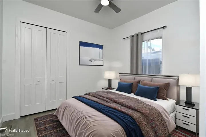Bedroom with a closet, dark wood-style flooring, and ceiling fan