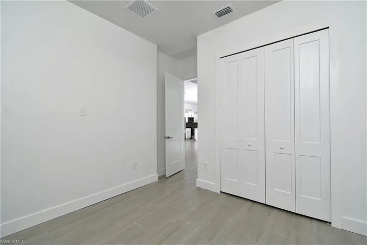 Unfurnished bedroom with light wood-style flooring and a closet